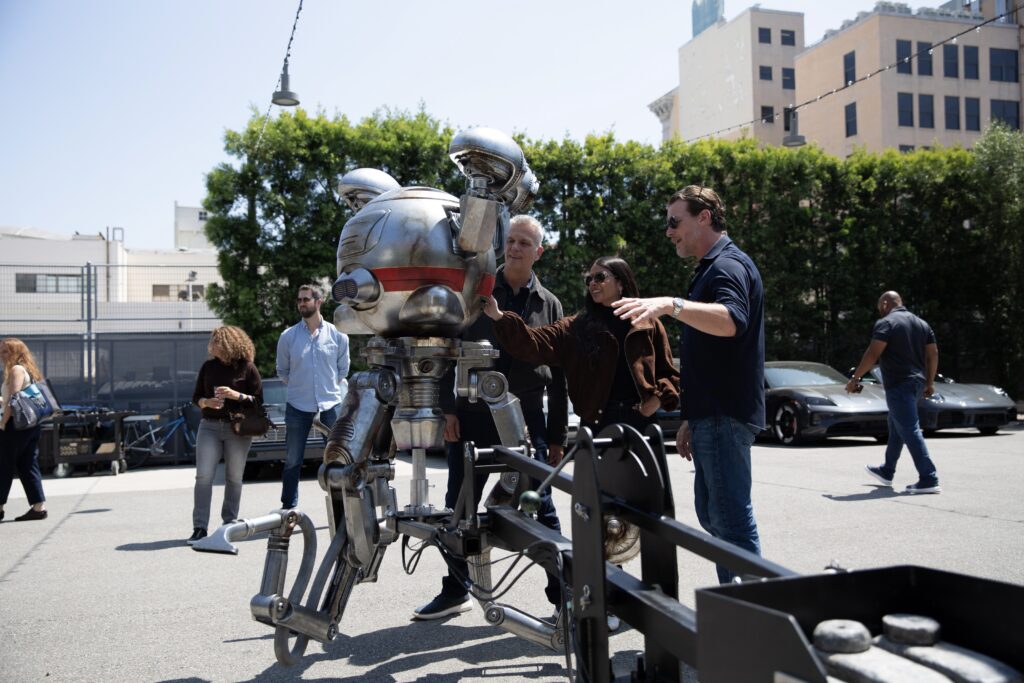 Jill Braff, James Altman, Matt Booty, Asha Sharma, and Jonathan Nolan look at robot Mr. Handy for 'Fallout' Season 3.